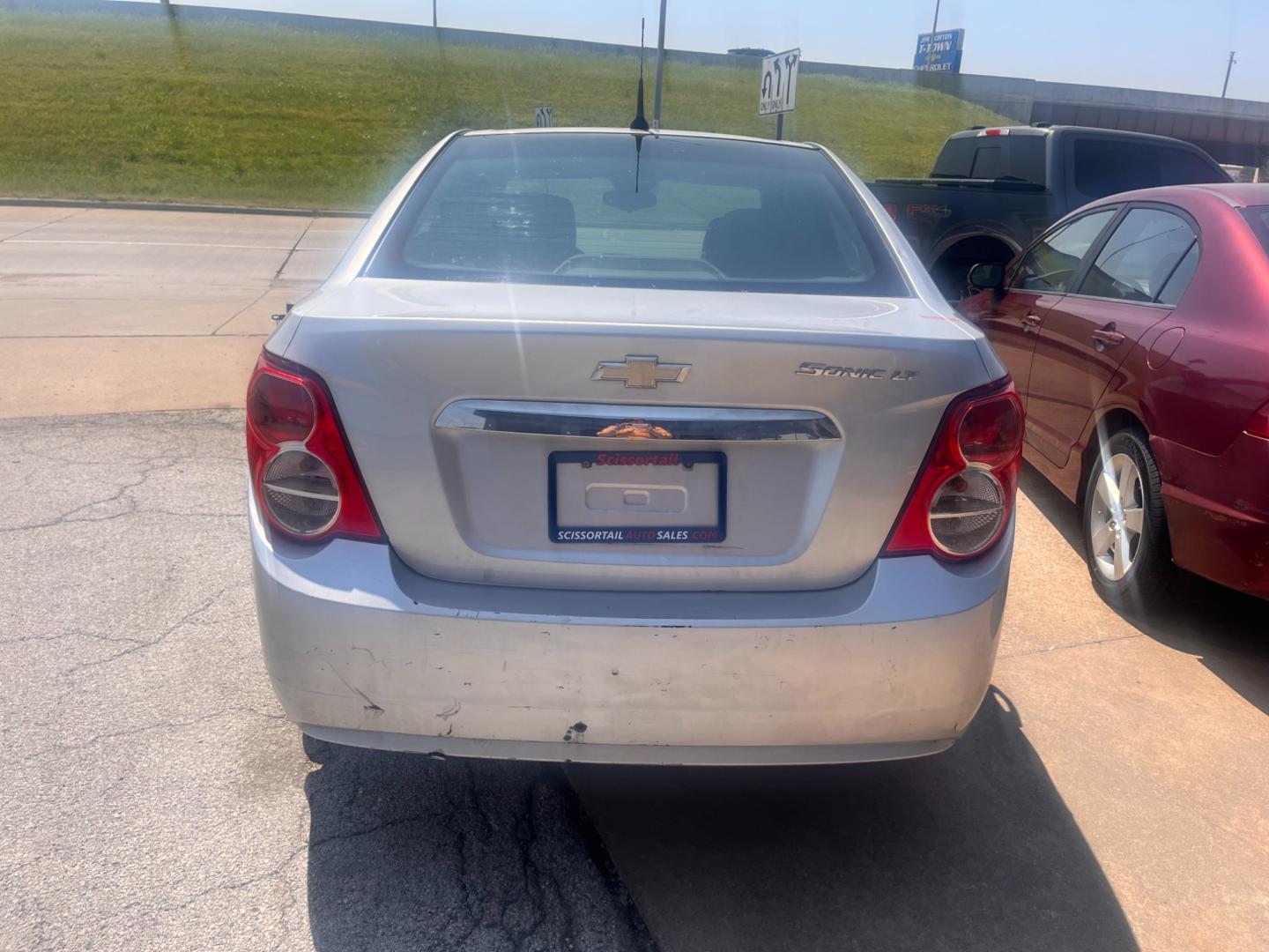 2013 SILVER Chevrolet Sonic LT Auto Sedan (1G1JC5SHXD4) with an 1.8L L4 DOHC 24V FFV engine, 6-Speed Automatic transmission, located at 8101 E. Skelly Dr., Tulsa, OK, 74129, (918) 592-3593, 36.121891, -95.888802 - Photo#4